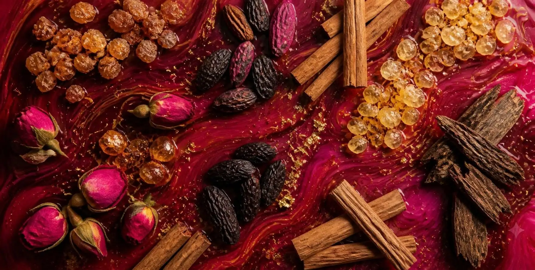 Agarwood, frankincense, sandalwood, tonka beans and rose buds on swirls of wine red