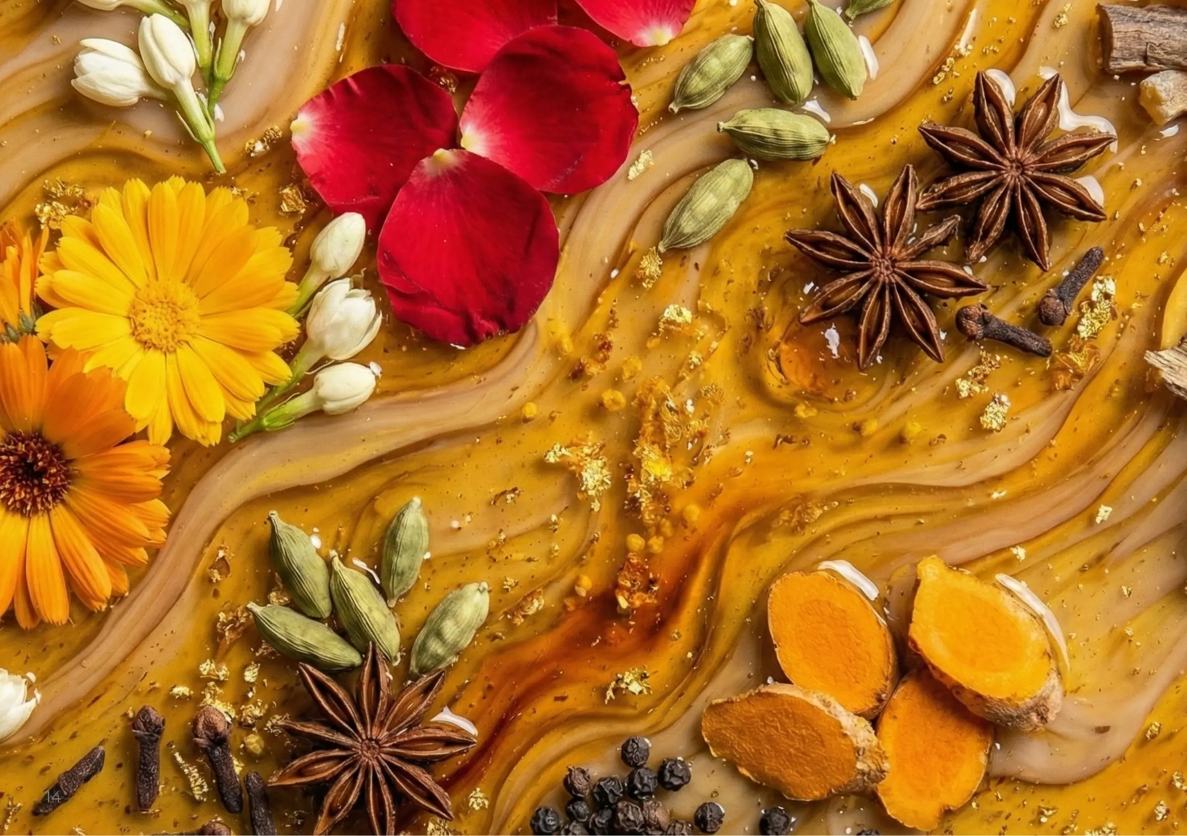 Rose petals, marigold, cardamom, turmeric and star anise on swirls of amber